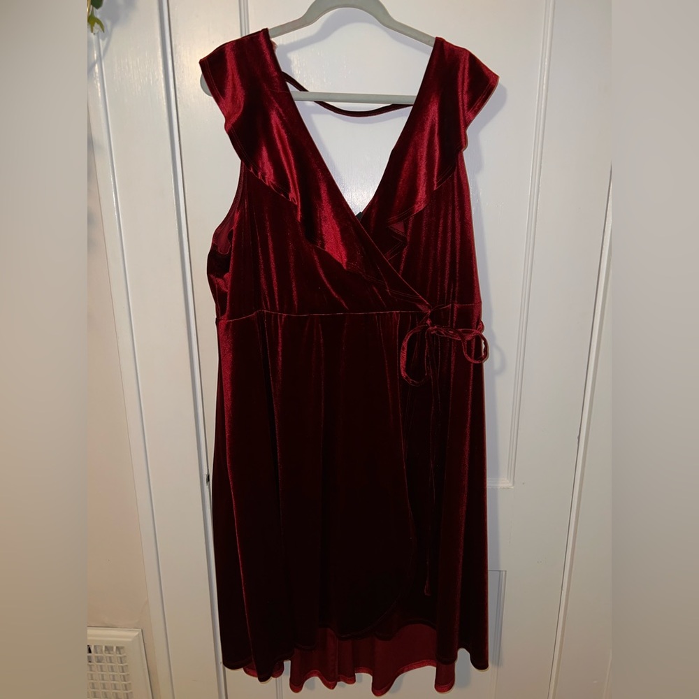 Red velvet wrap dress with flutter sleeves, and a bow to tie in the front.